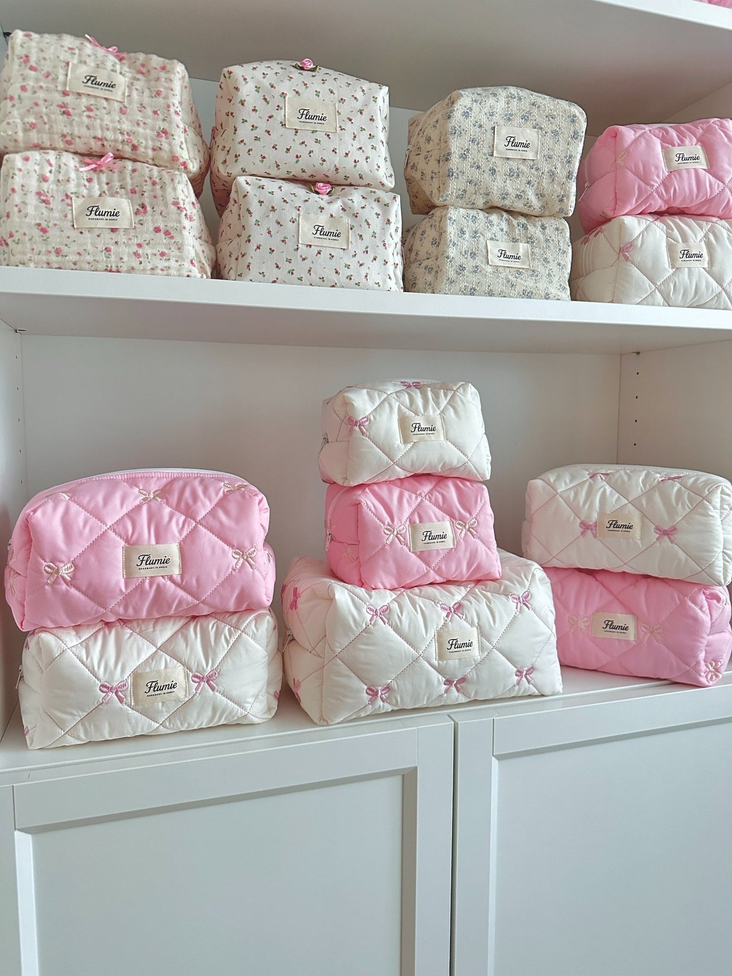 Ribbon Puff quilted pouches in pink & ivory by Flumie – displayed in shelf lineup
