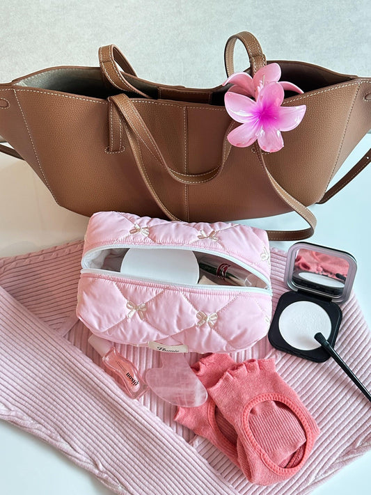 Pink quilted bow pouch styled with tote bag & daily essentials – feminine vibe
