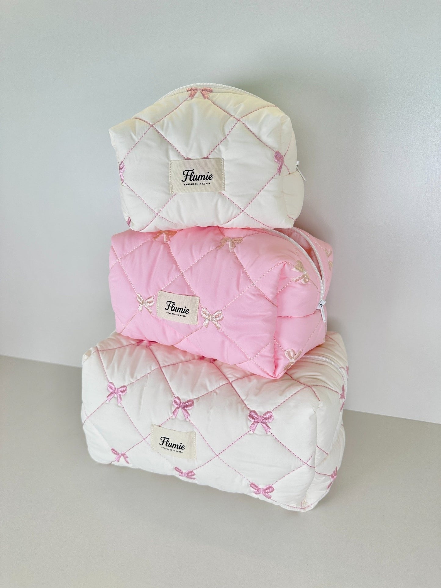 Flumie Ribbon Puff pouch set – small, medium, large stacked in pastel tones