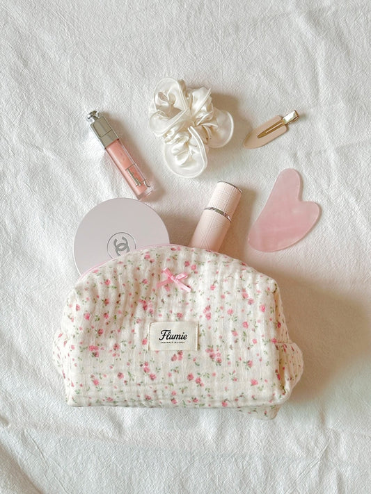 Rosymilk pouch styled with lip gloss, silk scrunchie & gua sha – clean girl mood