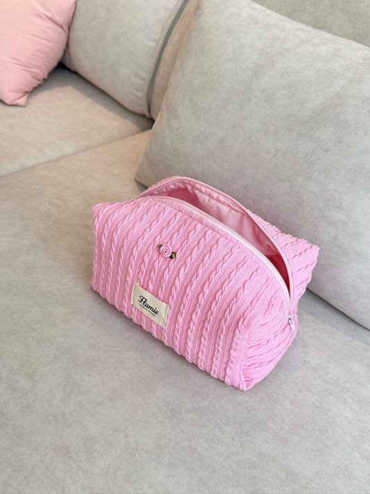 Strawberry pink cable knit pouch with rose detail, exuding a warm and sweet feeling
