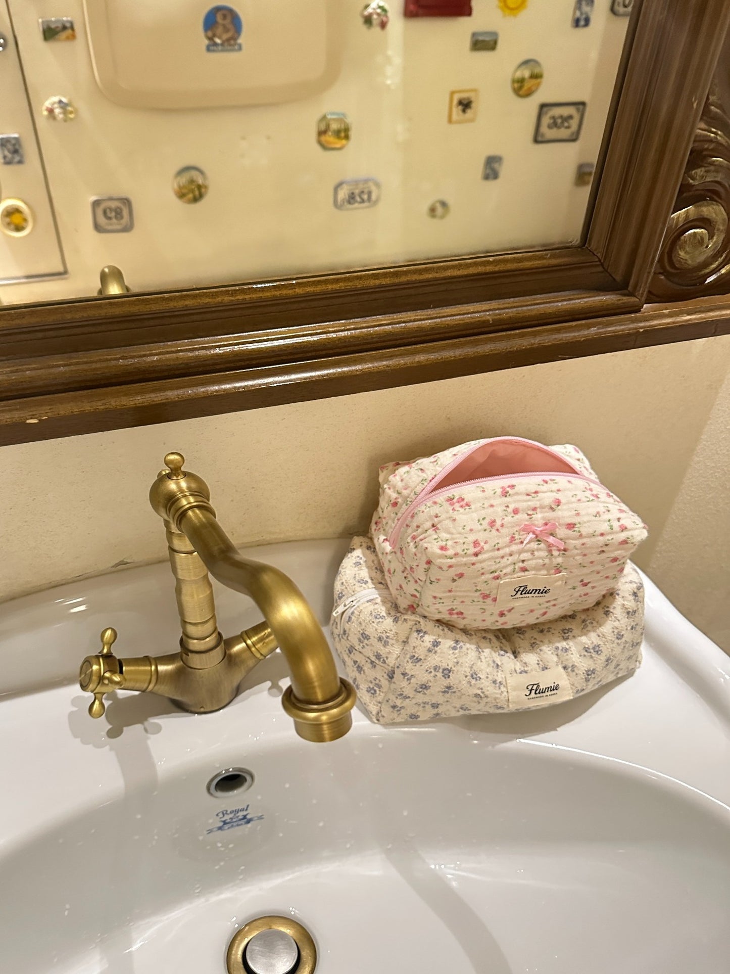 Rosymilk and another Flumie pouch on a vintage sink with brass faucet