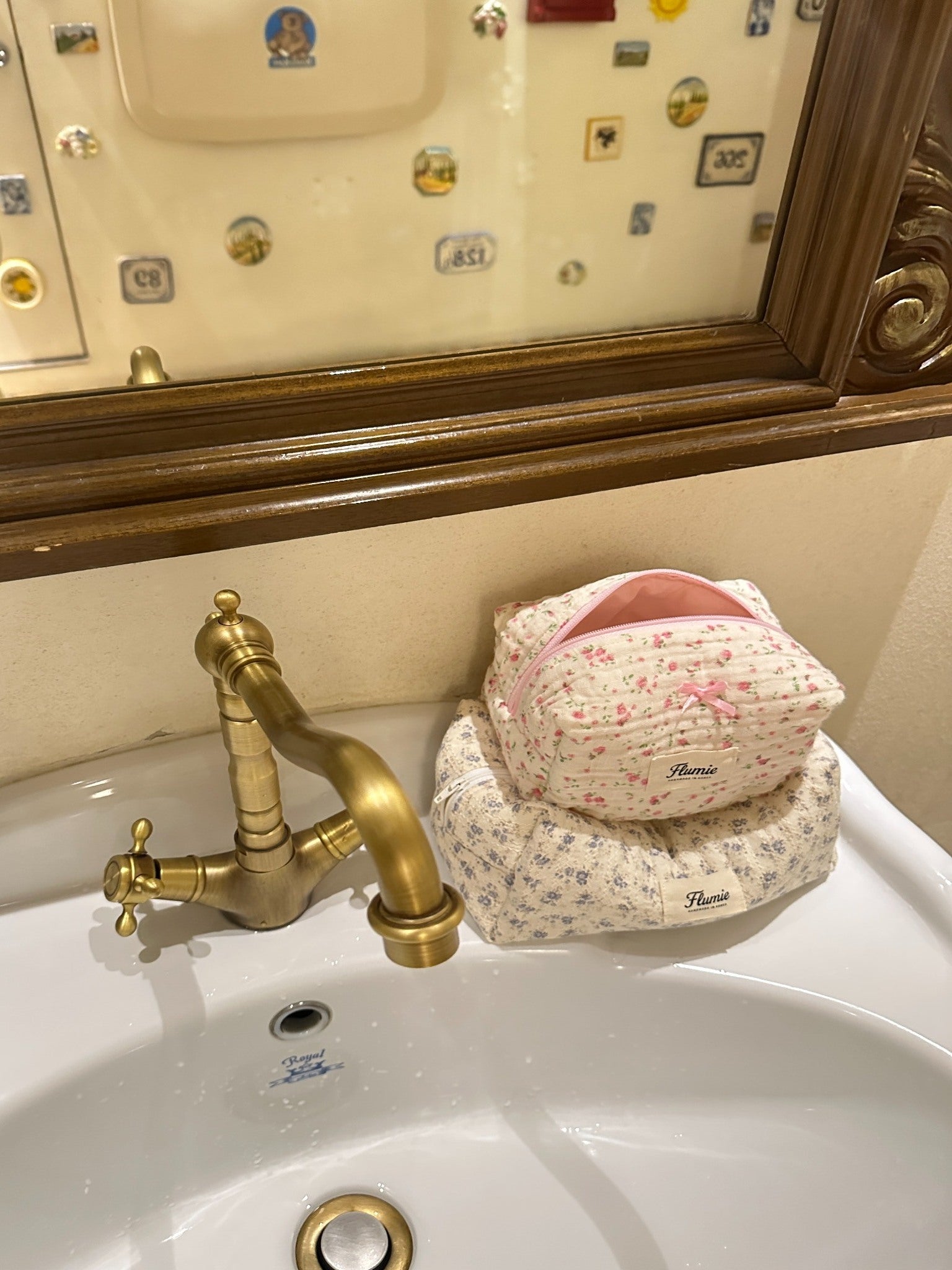 Rosymilk and another Flumie pouch on a vintage sink with brass faucet