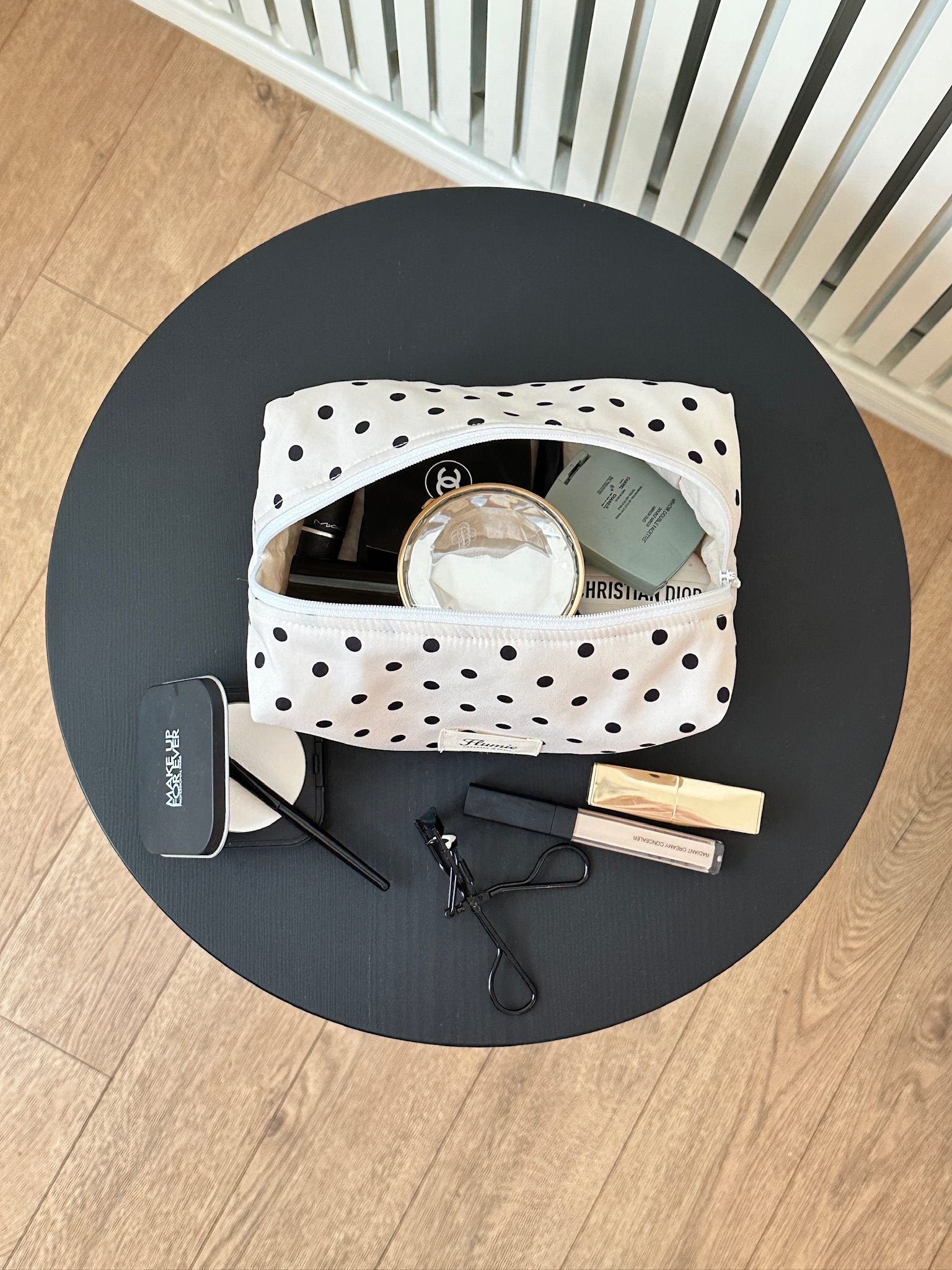 Classic black dots on ivory fabric add a playful charm to this aesthetic handmade pouch