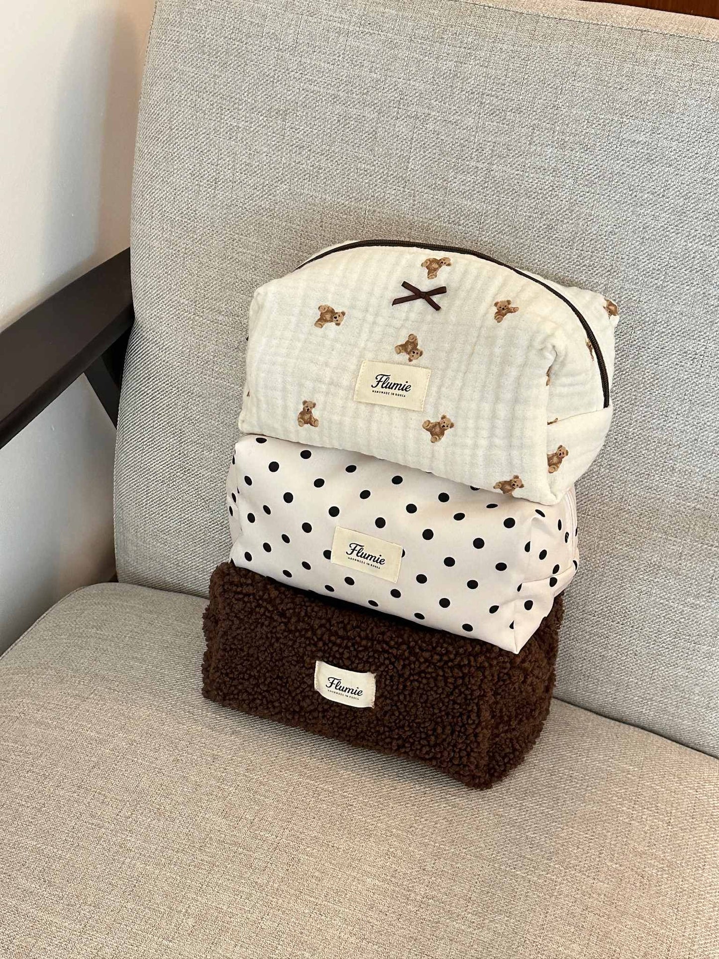 Classic black dots on ivory fabric add a playful charm to this aesthetic handmade pouch