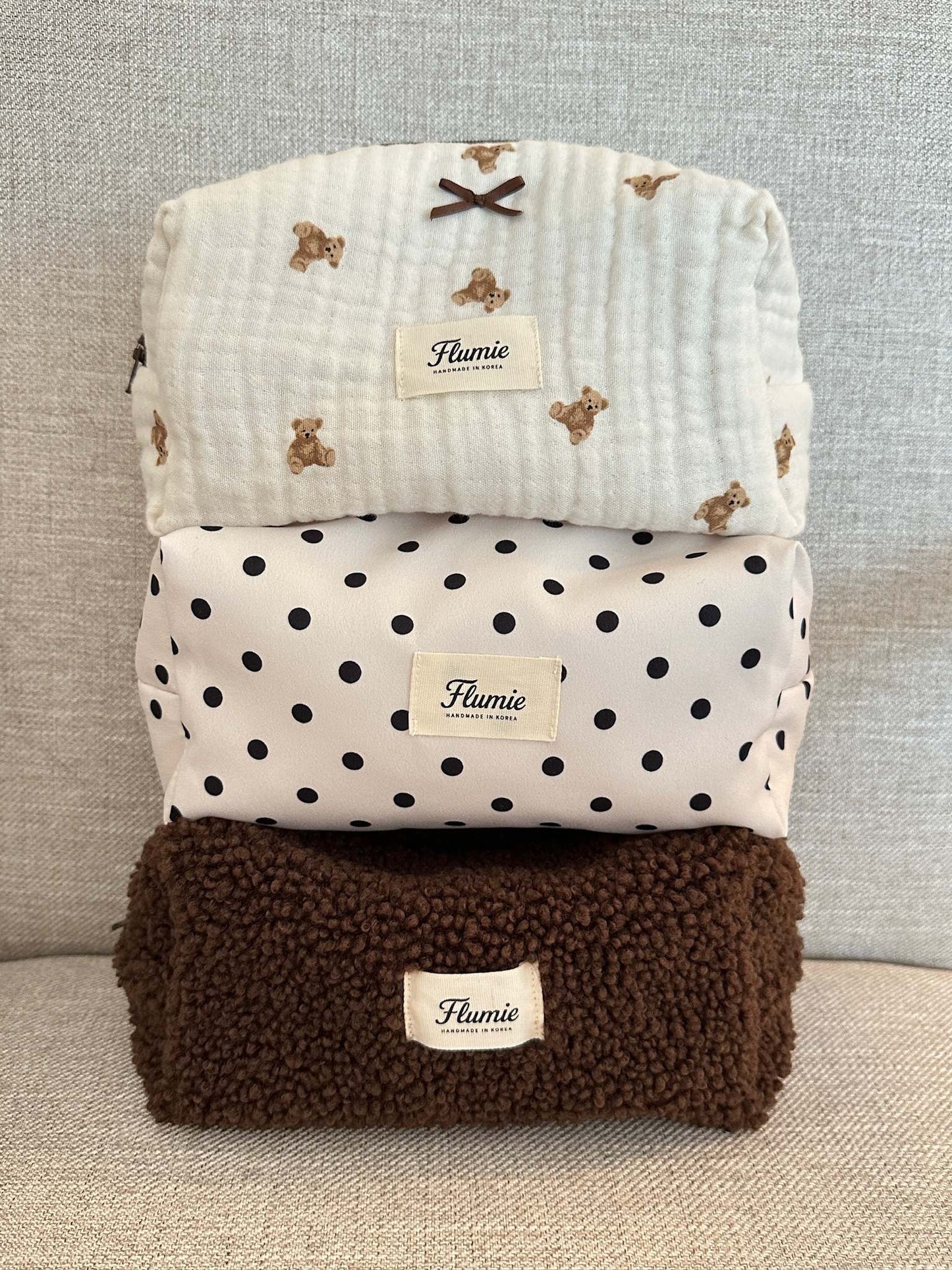 Classic black dots on ivory fabric add a playful charm to this aesthetic handmade pouch