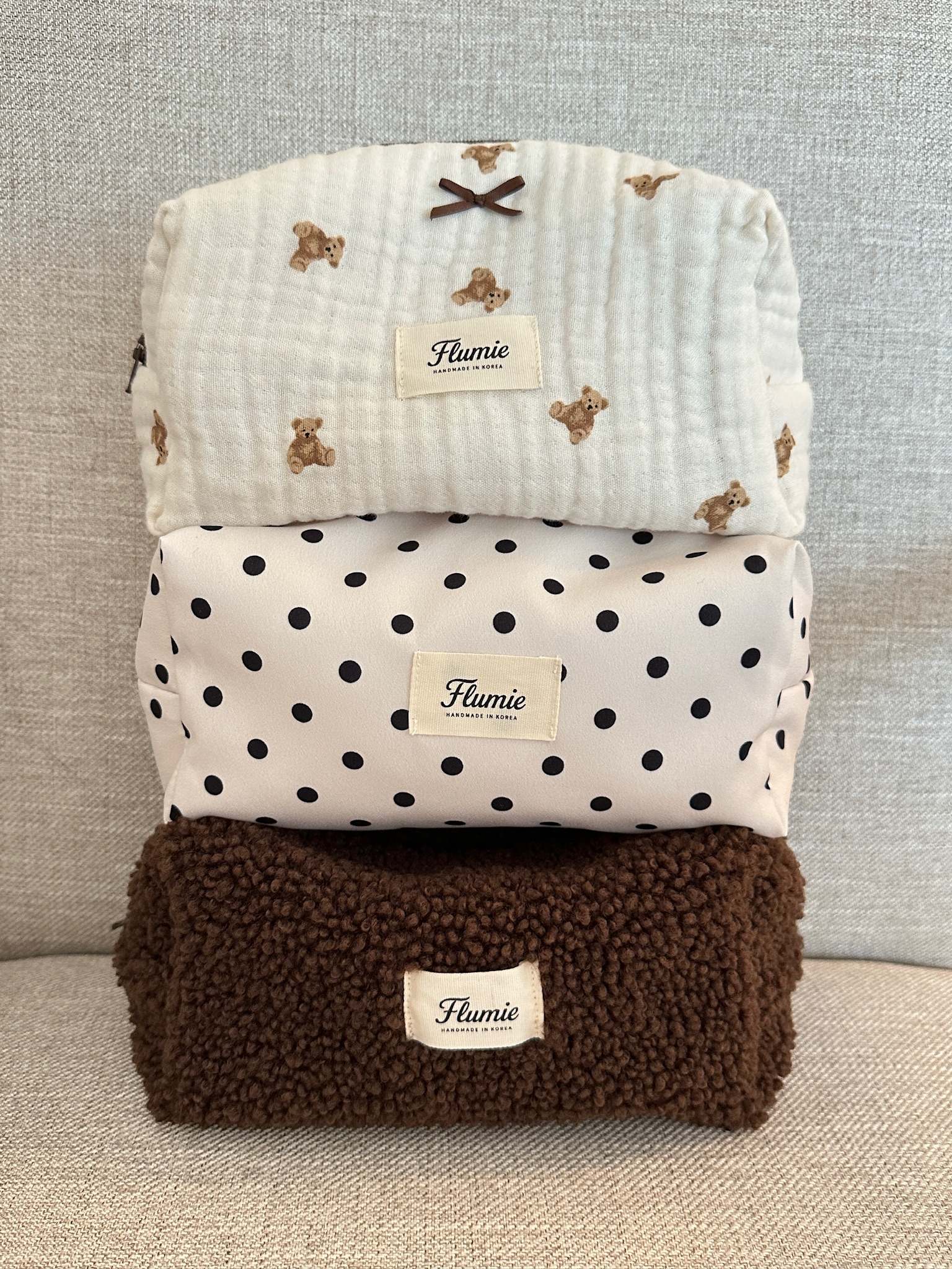 Classic black dots on ivory fabric add a playful charm to this aesthetic handmade pouch