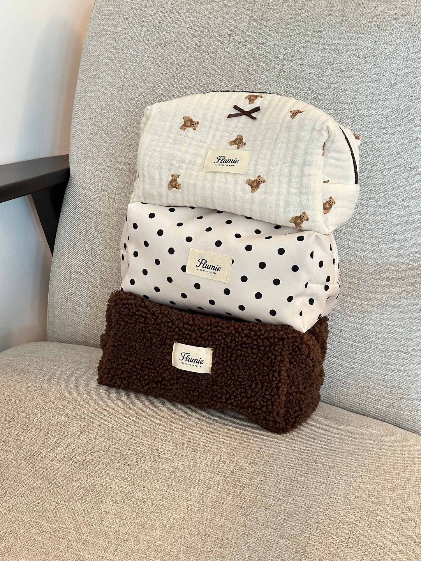 Classic black dots on ivory fabric add a playful charm to this aesthetic handmade pouch