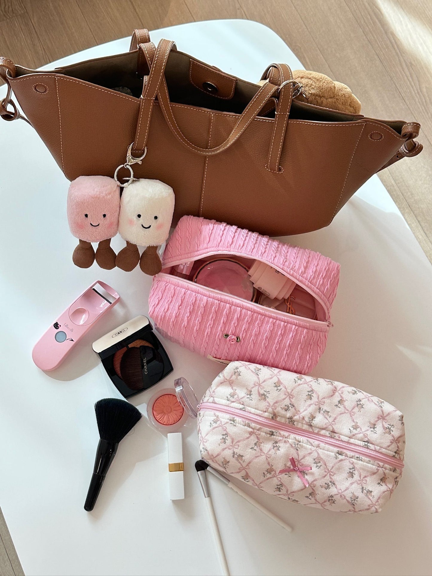 Strawberry pink cable knit pouch with rose detail, exuding a warm and sweet feeling