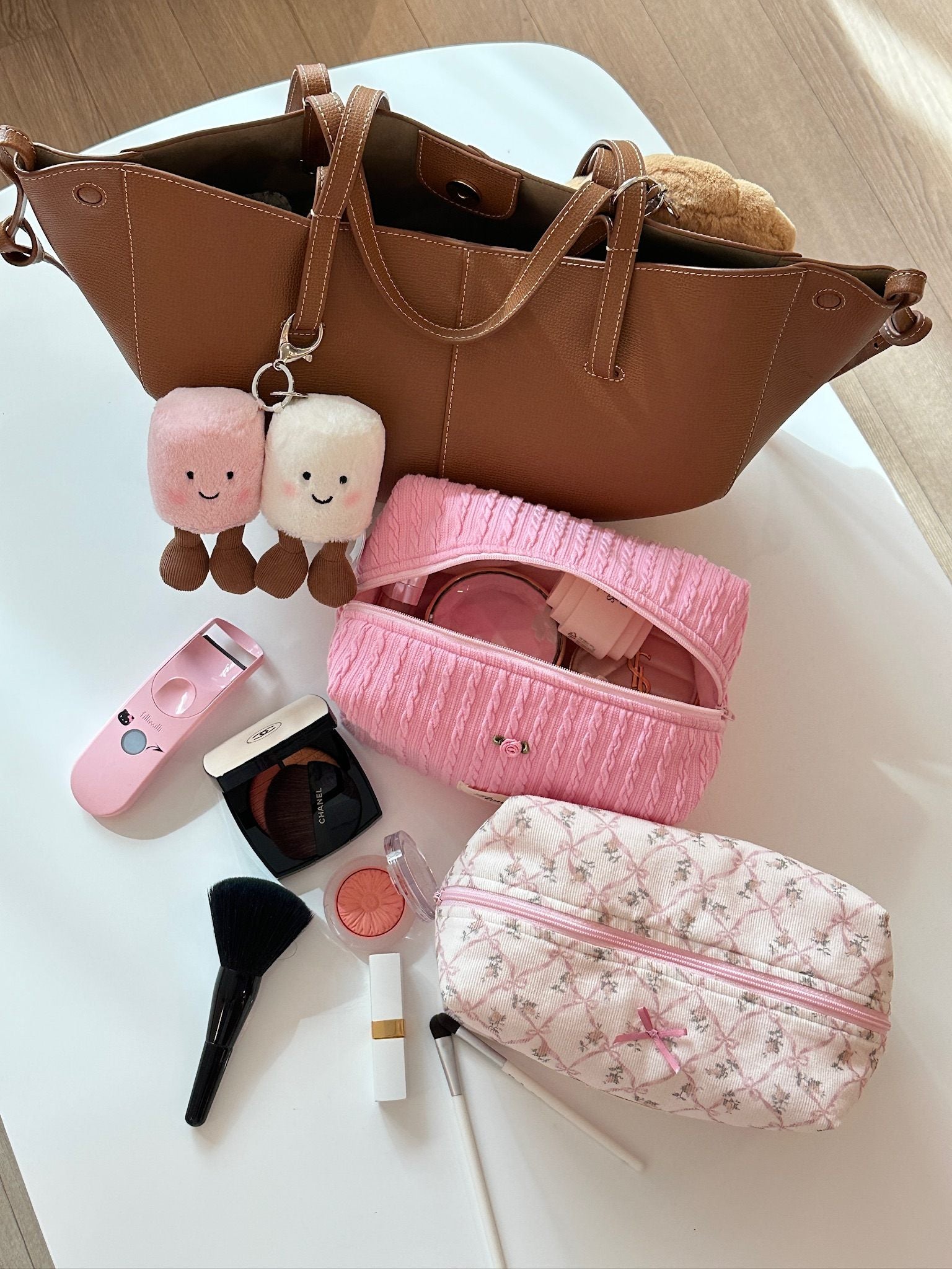 Strawberry pink cable knit pouch with rose detail, exuding a warm and sweet feeling